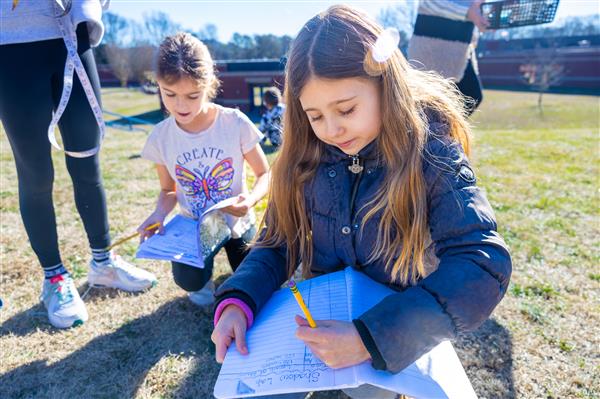 girl writing in notebook